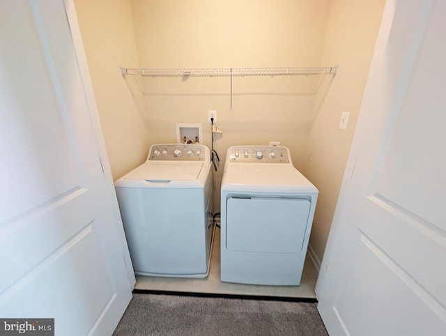 clothes washing area featuring independent washer and dryer, laundry area, and carpet