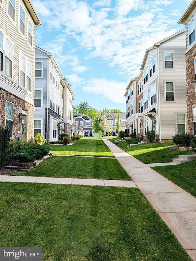 view of community with a yard and a residential view