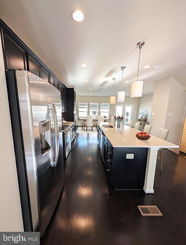 kitchen featuring visible vents, dark wood-style floors, recessed lighting, light countertops, and appliances with stainless steel finishes