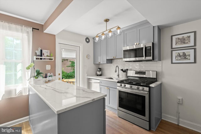 1705 N Cliff St, Alexandria, VA 22301 - kitchen with appliances with stainless steel finishes, a sink, gray cabinets, and decorative backsplash