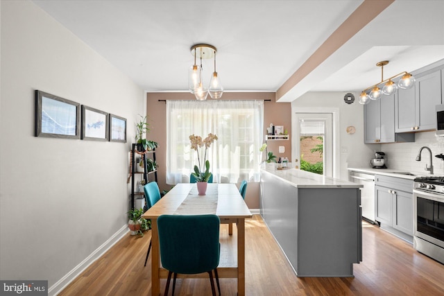 1705 N Cliff St, Alexandria, VA 22301 - kitchen with stainless steel appliances, a sink, gray cabinets, a peninsula, and tasteful backsplash