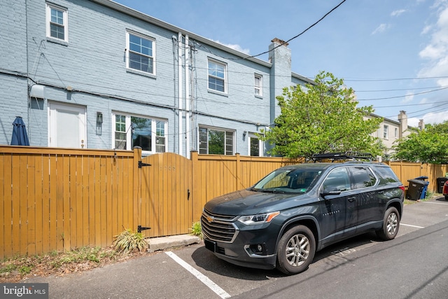 1705 N Cliff St, Alexandria, VA 22301 - view of side of home featuring a gate, uncovered parking, and a chimney