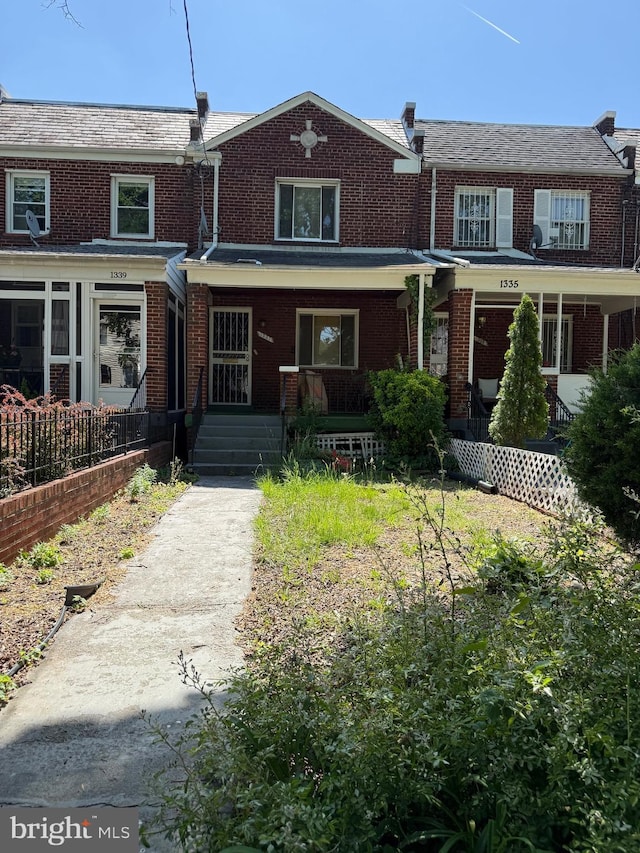 view of front facade with a porch and brick siding