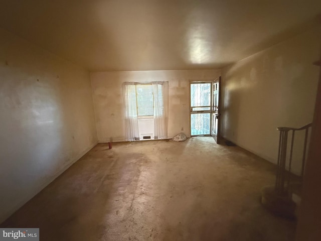 unfurnished room featuring unfinished concrete flooring
