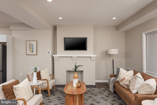 living room featuring recessed lighting, baseboards, visible vents, and a fireplace