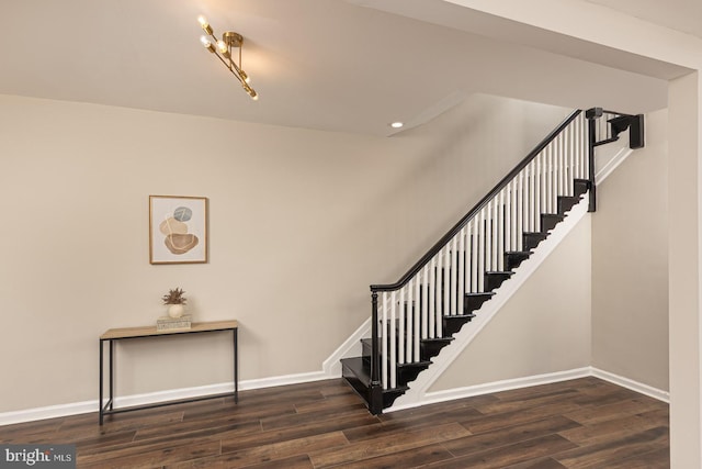 stairs with baseboards and wood finished floors