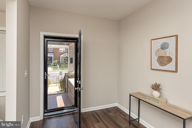 entryway with baseboards, dark wood-style flooring, and a wealth of natural light