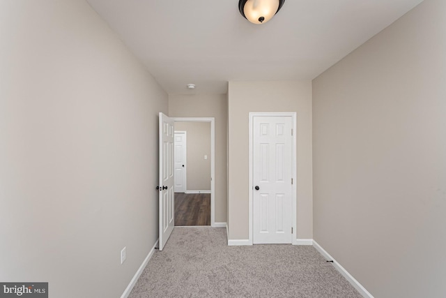 interior space featuring baseboards and carpet flooring