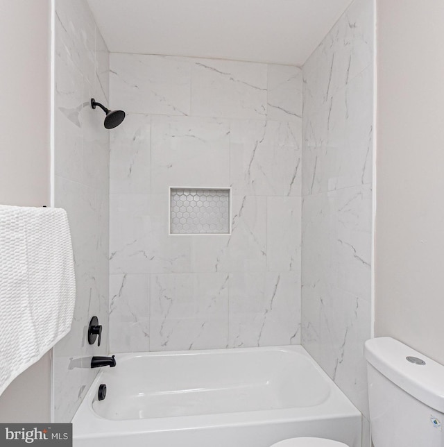 bathroom with bathtub / shower combination and toilet