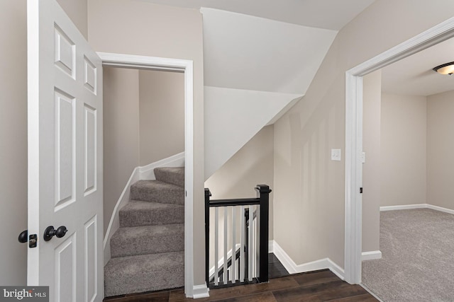 staircase with baseboards and wood finished floors