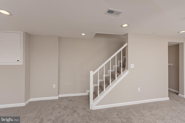 basement with visible vents, stairs, baseboards, recessed lighting, and carpet