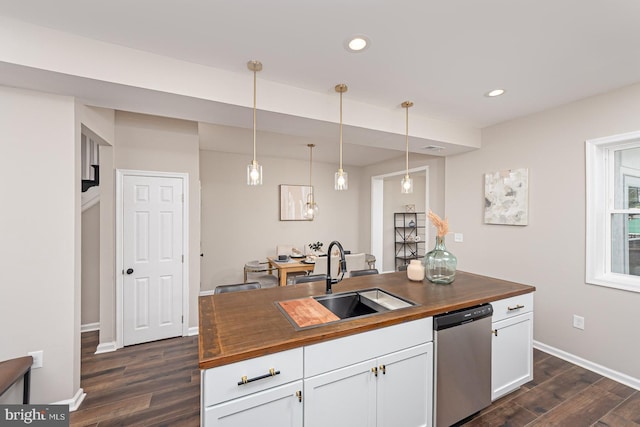 kitchen featuring wooden counters, white cabinetry, a sink, dark wood finished floors, and dishwasher