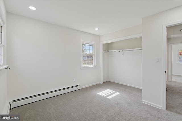 unfurnished bedroom featuring baseboard heating, carpet floors, baseboards, a closet, and recessed lighting