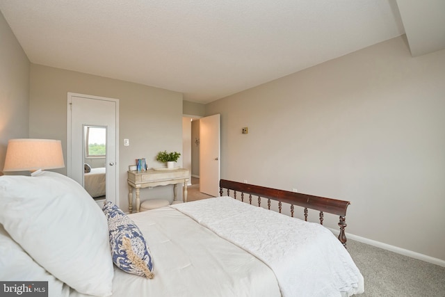 carpeted bedroom featuring baseboards