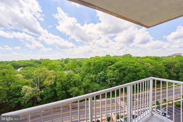 balcony featuring a view of trees