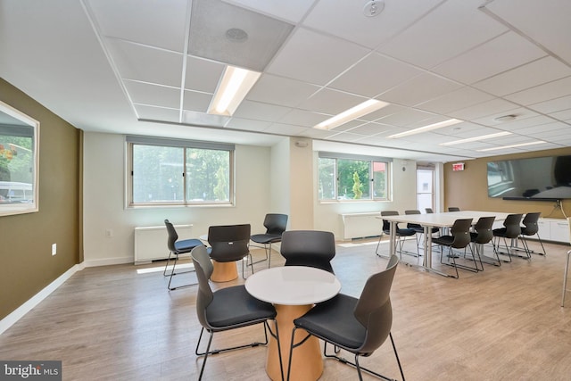 dining area with baseboards and light wood finished floors