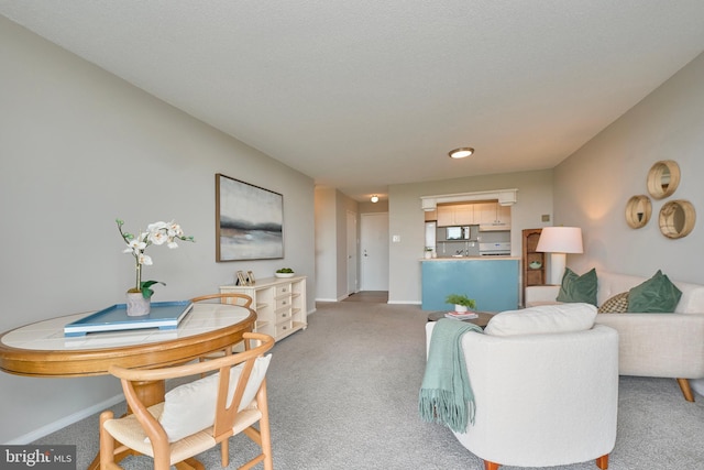 living room featuring baseboards and light colored carpet