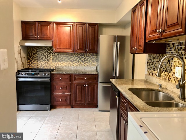 8317 Irongate Way, Manassas, VA 20109 - kitchen with appliances with stainless steel finishes, range hood, a sink, tasteful backsplash, and light tile patterned floors