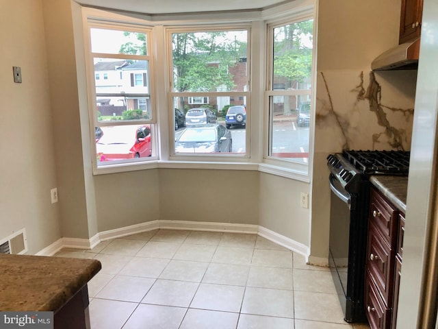 8317 Irongate Way, Manassas, VA 20109 - kitchen with gas stove, plenty of natural light, light tile patterned flooring, and baseboards