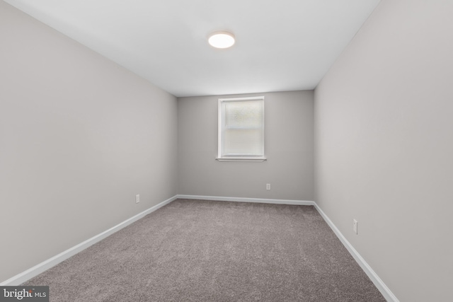 unfurnished room featuring baseboards and carpet floors