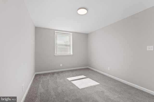 carpeted empty room with baseboards