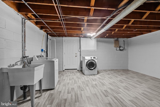 laundry room with washing machine and dryer, wood finished floors, and laundry area