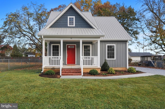 41 S Mechanic St, Camden Wyoming, DE 19934 - bungalow with fence, a front yard, board and batten siding, metal roof, and a porch