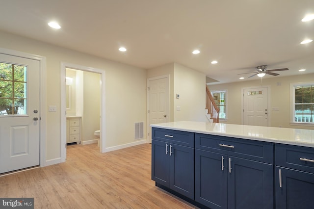 41 S Mechanic St, Camden Wyoming, DE 19934 - kitchen with light countertops, blue cabinetry, recessed lighting, light wood-type flooring, and visible vents