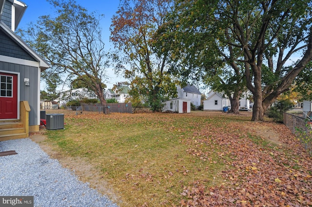 41 S Mechanic St, Camden Wyoming, DE 19934 - view of yard featuring an outdoor structure, central AC, fence, entry steps, and a storage shed