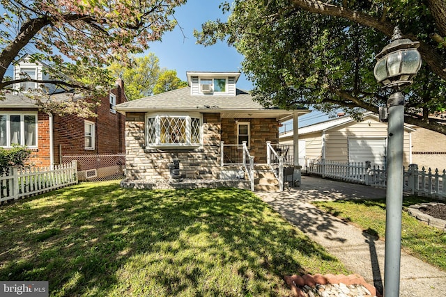 1016 Leiper St, Crum Lynne, PA 19022 - bungalow-style house featuring stone siding, fence, a shingled roof, and a front yard