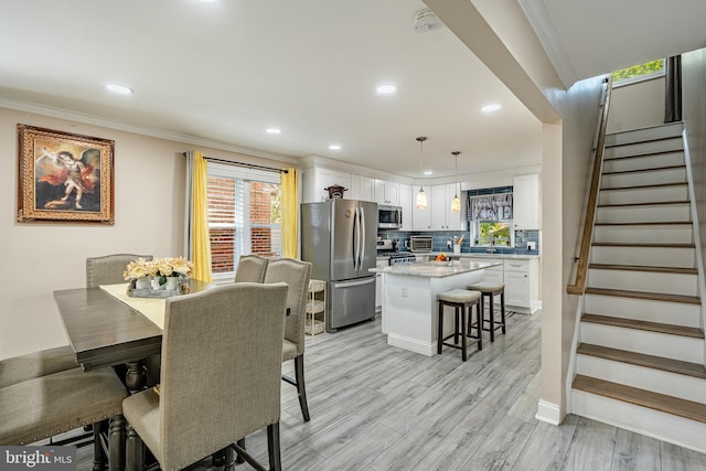 1016 Leiper St, Crum Lynne, PA 19022 - dining space with crown molding, stairs, a toaster, light wood-style floors, and recessed lighting