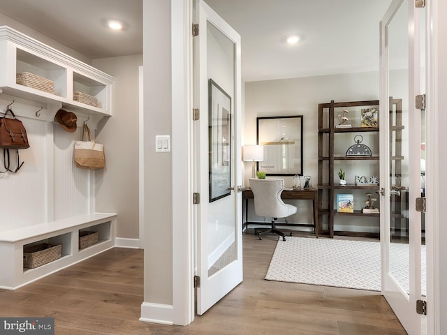 mudroom with baseboards and wood finished floors