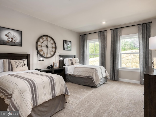 carpeted bedroom featuring baseboards