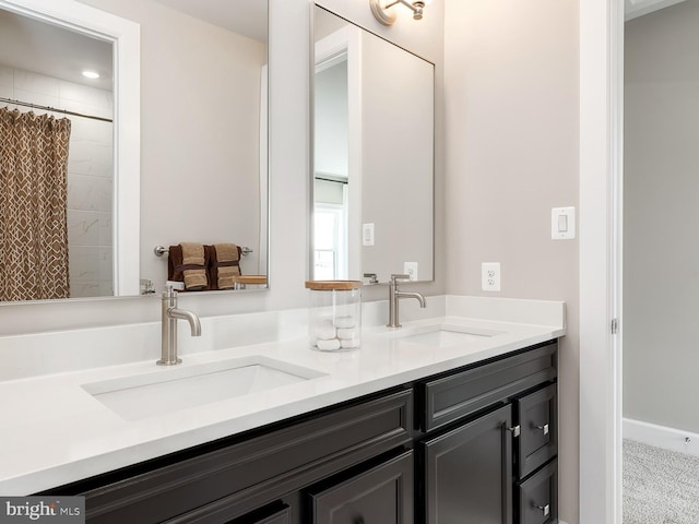 bathroom featuring double vanity, a sink, and curtained shower