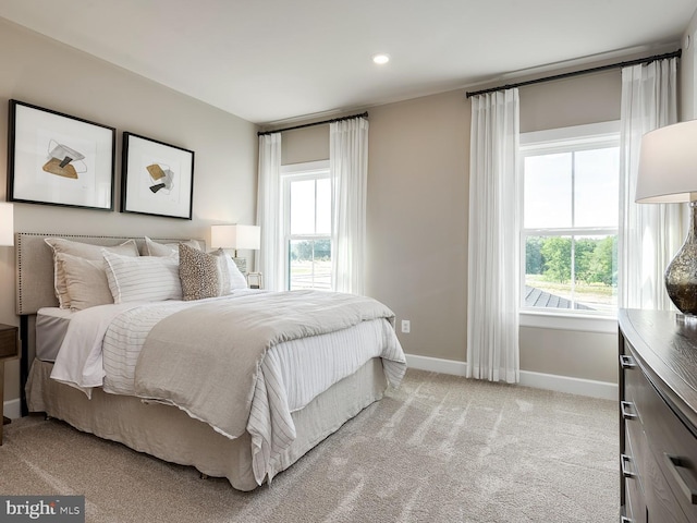 bedroom featuring baseboards, recessed lighting, and light carpet