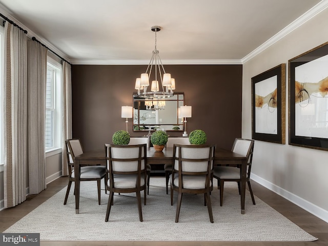 dining room with crown molding, baseboards, an inviting chandelier, and wood finished floors