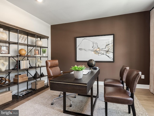 office area with baseboards and wood finished floors