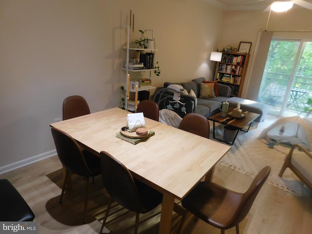 dining space featuring ceiling fan and wood finished floors