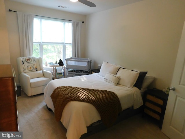 bedroom with visible vents, carpet, and ceiling fan