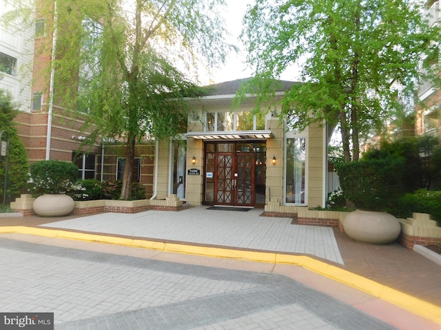 doorway to property featuring french doors and a standing seam roof