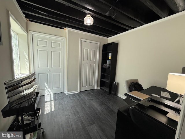 office space with baseboards and dark wood-style floors
