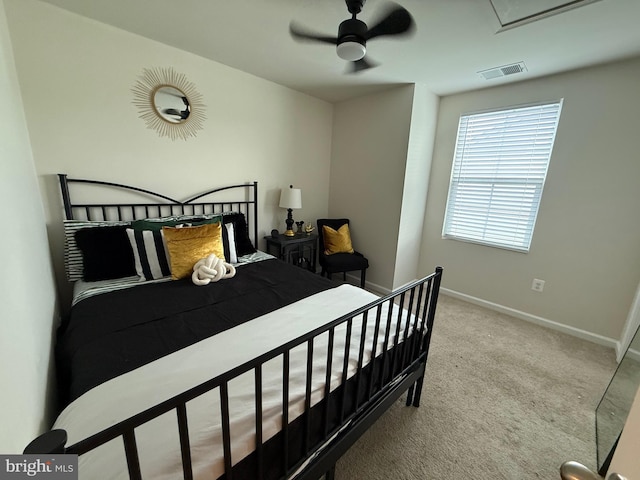 carpeted bedroom with a ceiling fan, baseboards, and visible vents