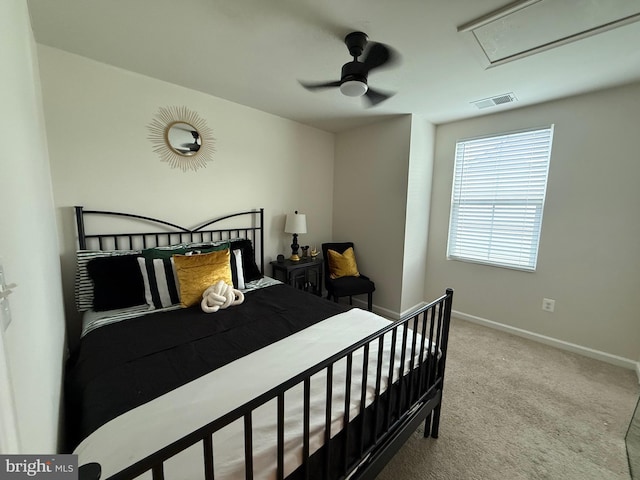 bedroom with ceiling fan, attic access, visible vents, carpet floors, and baseboards