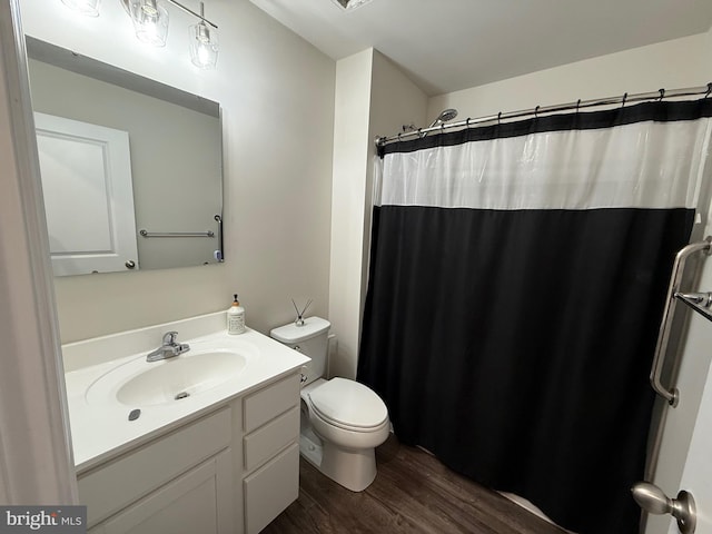 full bath with vanity, toilet, wood finished floors, and a shower with shower curtain