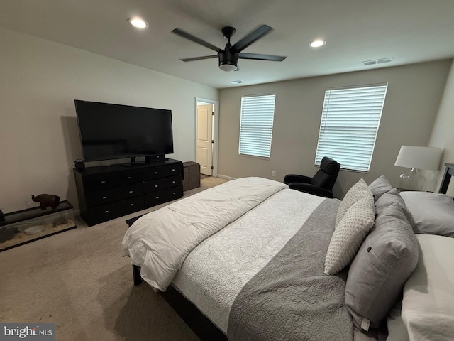 bedroom with visible vents, recessed lighting, a ceiling fan, and light carpet