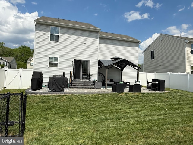 back of house with an outdoor living space, a gate, a patio area, and a lawn