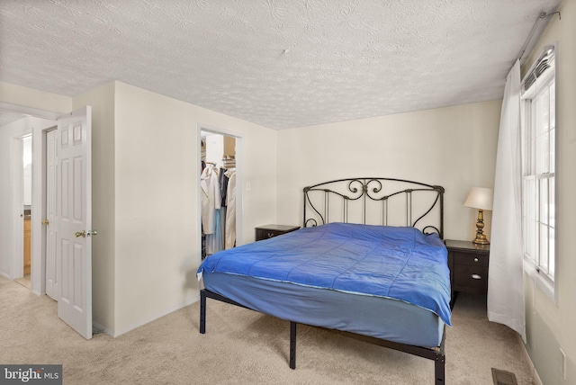 8337 Wind Fall Rd, Springfield, VA 22153 - carpeted bedroom with a textured ceiling, a walk in closet, baseboards, and a closet