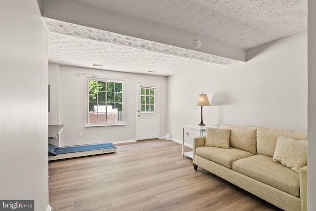 8337 Wind Fall Rd, Springfield, VA 22153 - living area with wood finished floors, a textured ceiling, beam ceiling, and baseboards