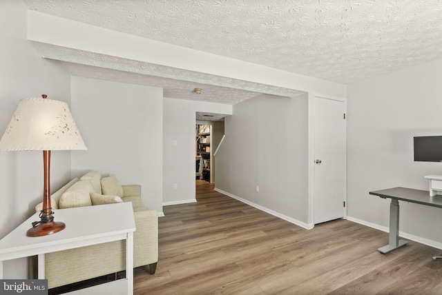 8337 Wind Fall Rd, Springfield, VA 22153 - living room with wood finished floors, a textured ceiling, and baseboards