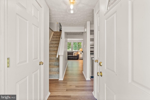8337 Wind Fall Rd, Springfield, VA 22153 - entryway featuring wood finished floors, stairway, a textured ceiling, and baseboards